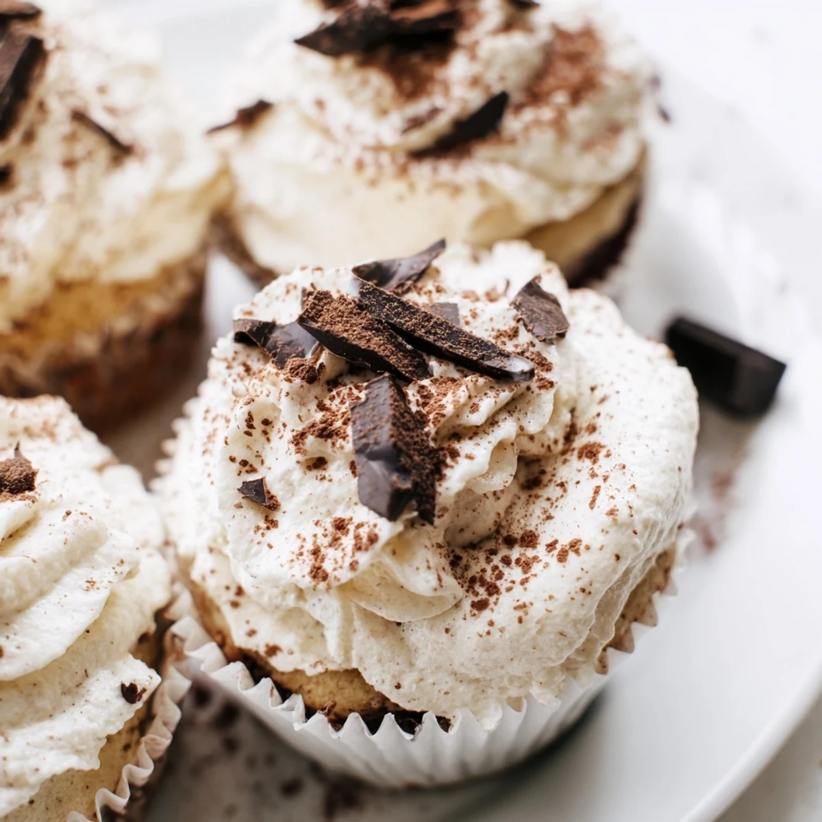 Decadent chocolate tiramisu cupcakes topped with fluffy mascarpone frosting and dusted cocoa powder