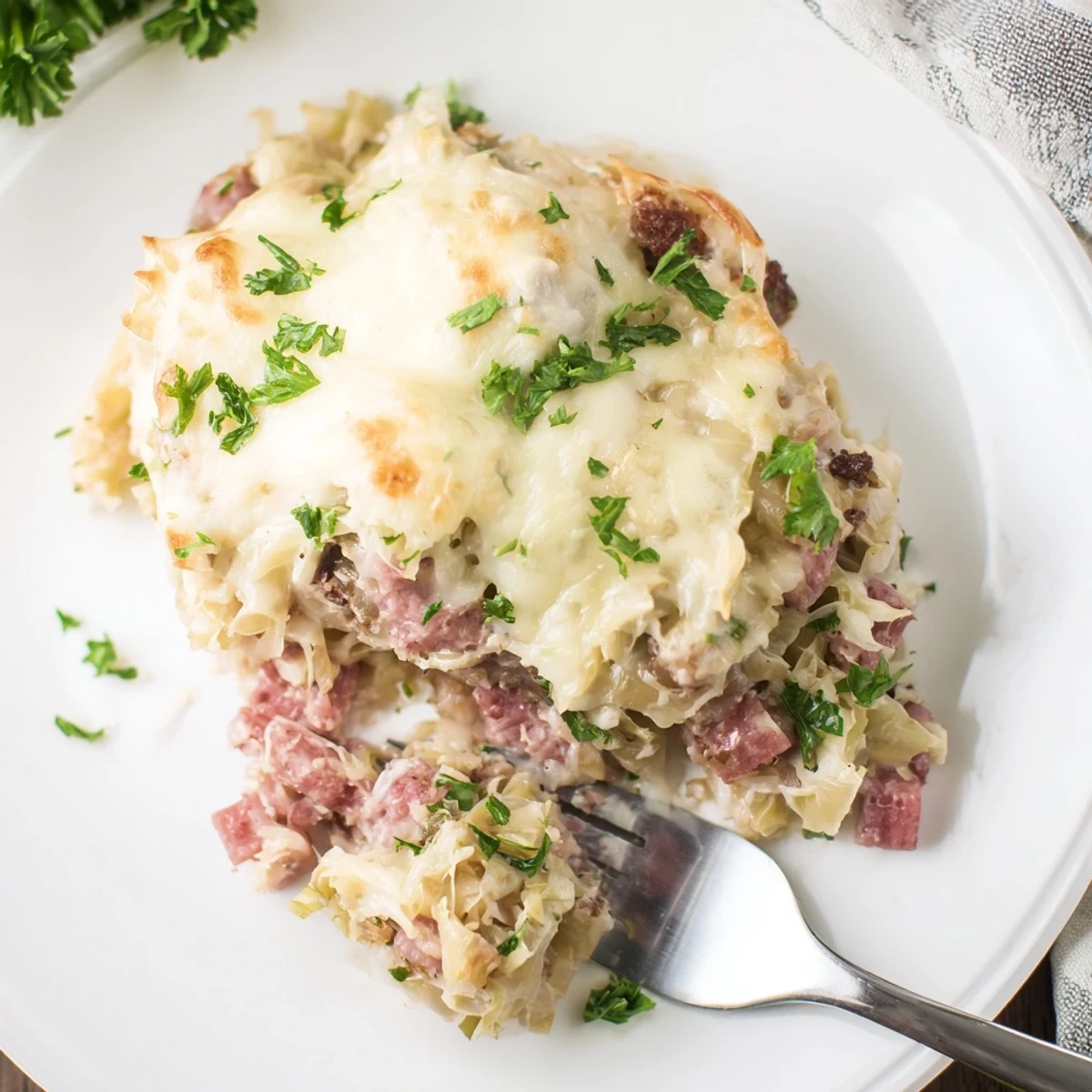 Creamy corned beef cabbage casserole featuring tender shredded cabbage and savory mozzarella parmesan crust