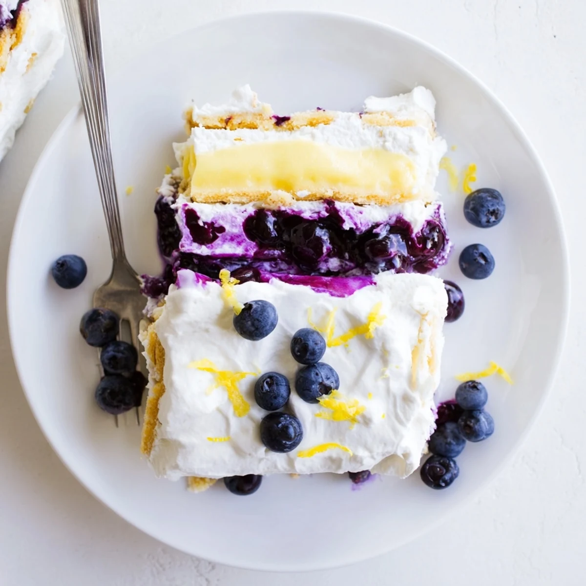 No-bake lemon blueberry lasagna recipe in a glass dish topped with fresh berries