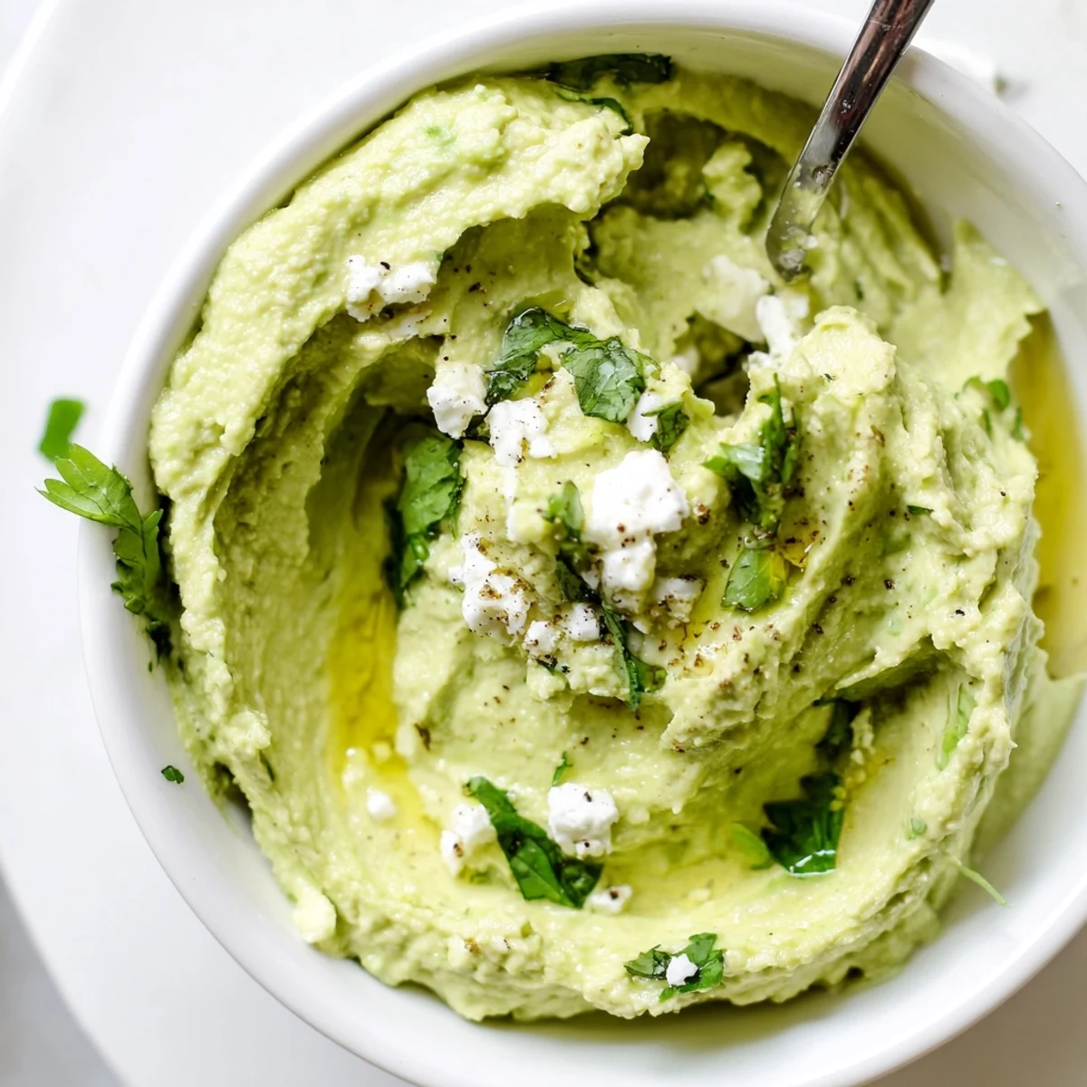 Bright tangy Creamy Avocado Feta Dip with crumbled feta, lime zest, cilantro