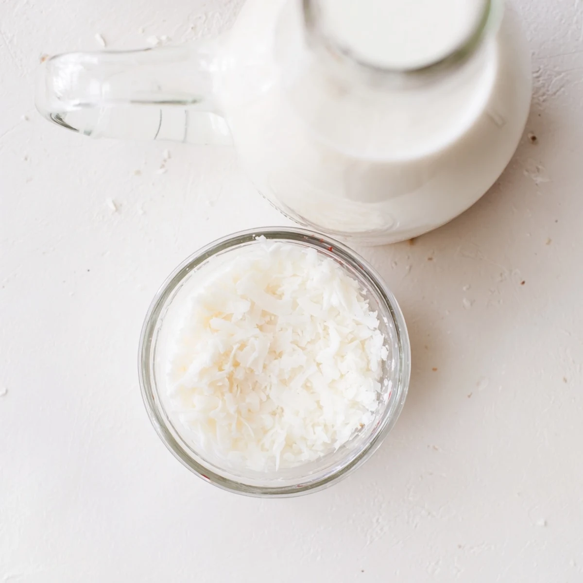 Fresh homemade coconut milk in a glass jar with white creamy texture