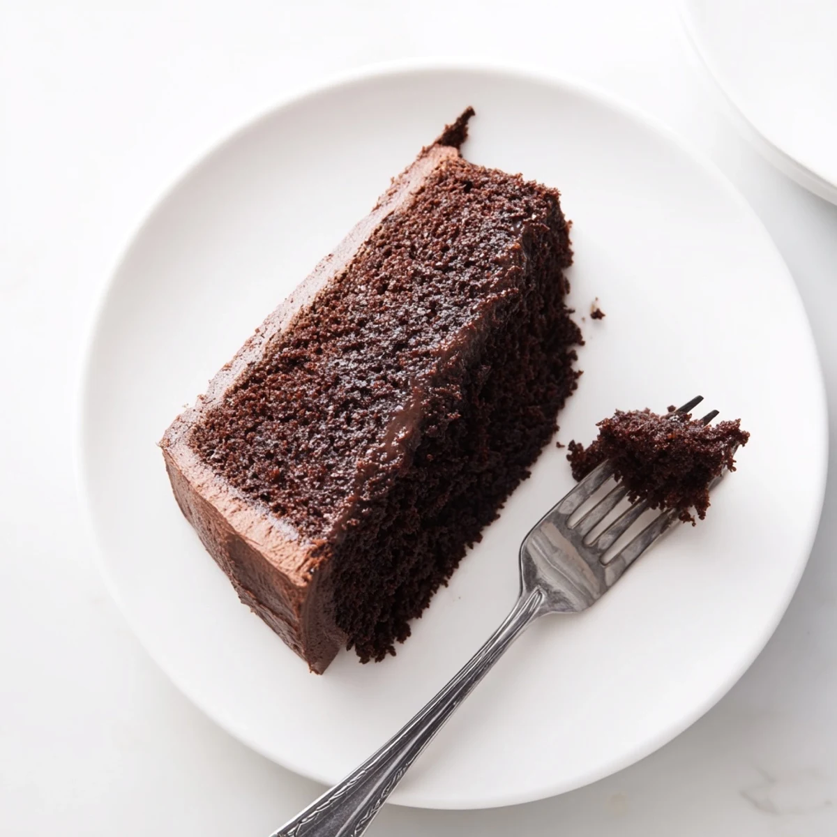 Moist chocolate mayonnaise cake with tender crumb topped with rich chocolate frosting