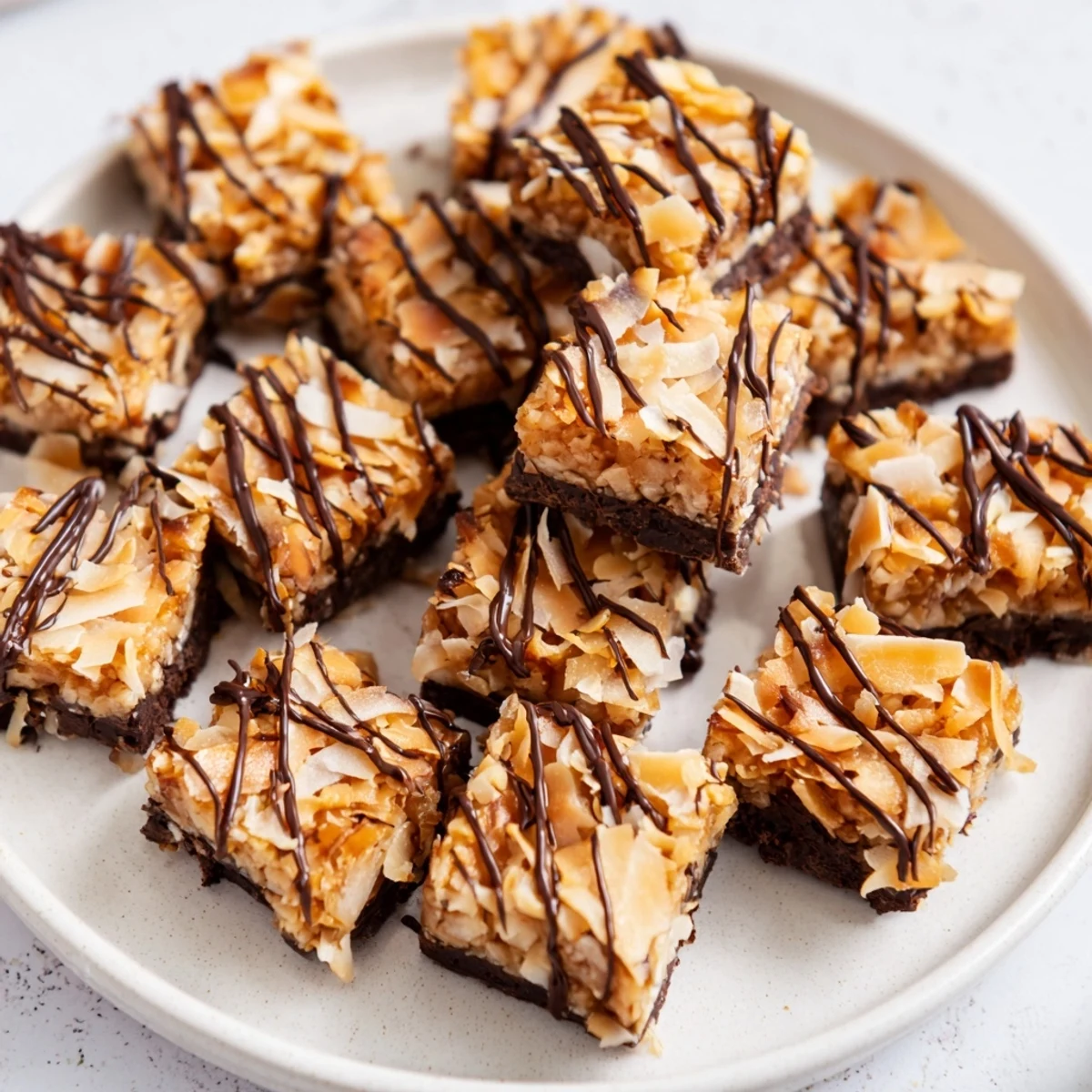 Homemade no bake Samoa bites featuring rich chocolate coating and crunchy coconut topping