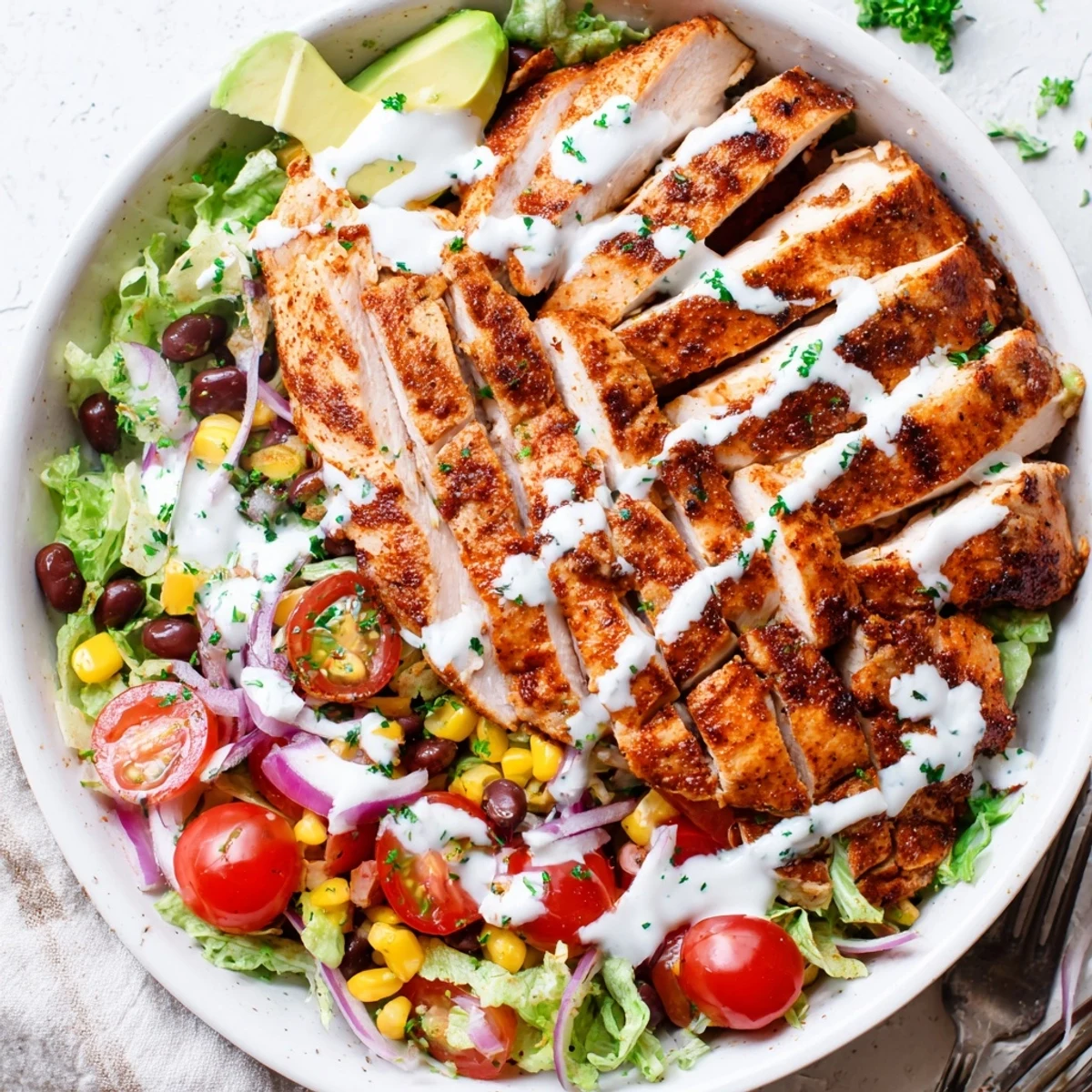 Spicy Southwest Salad With Spicy Ranch Dressing drizzled in creamy, tangy heat for sharing