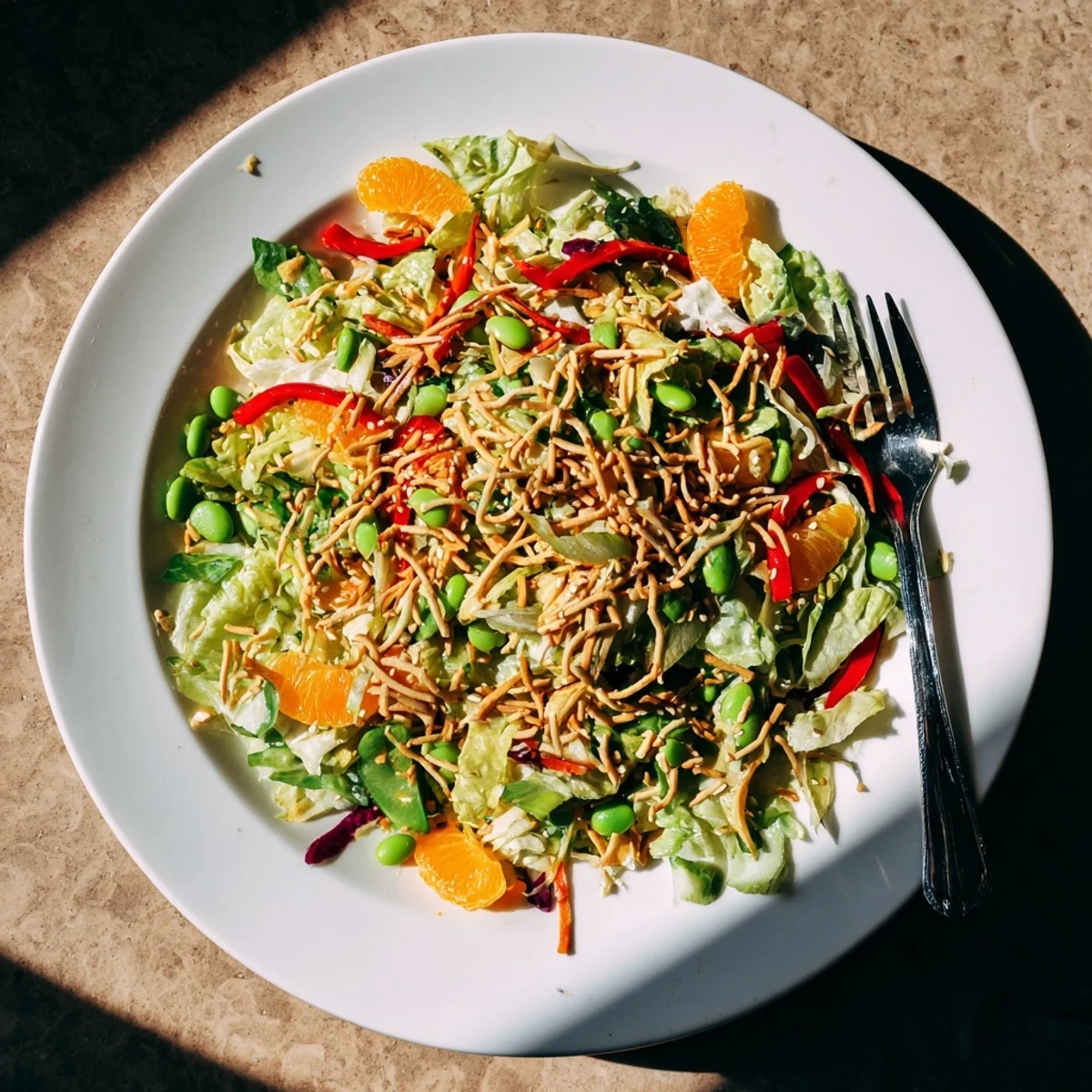 Mandarin Sesame Crunch Salad with juicy orange segments, crisp vegetables, and a glossy sesame ginger dressing